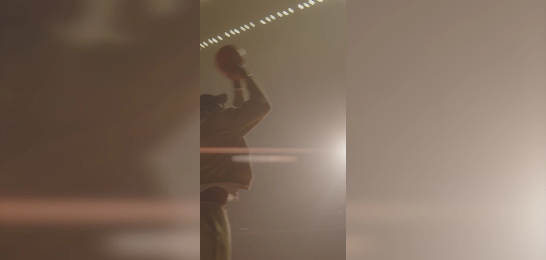 Video still from the Lucky Energy site: a figure in soft light in a dark room